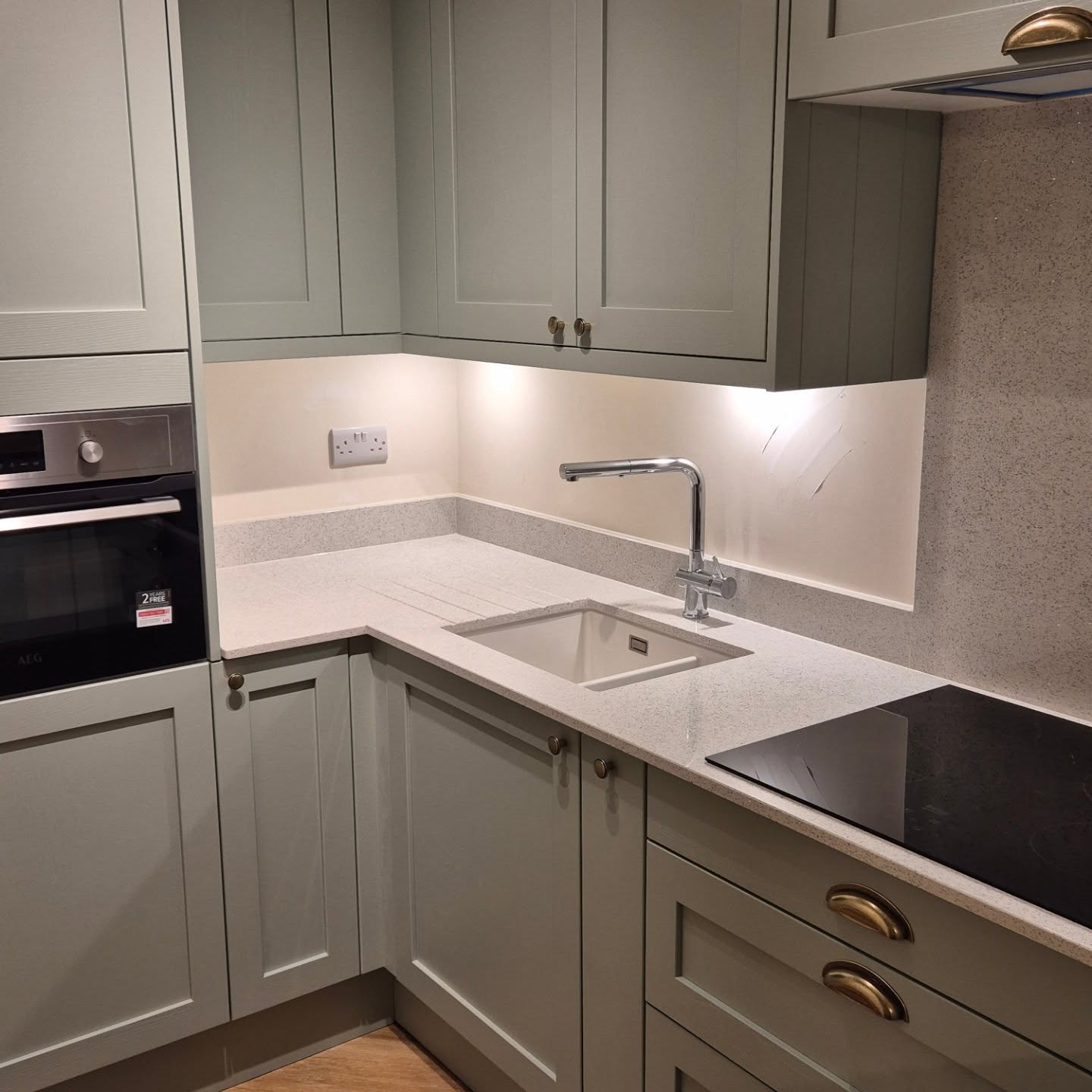 Sage green Shaker-style fitted kitchen installed by Paul Lynam in Bath