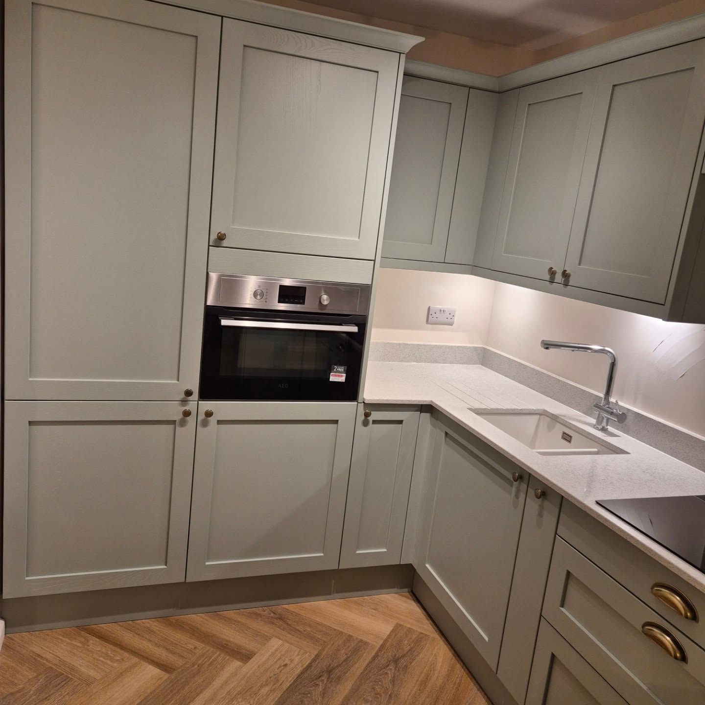 Sage green Shaker-style fitted kitchen installed by Paul Lynam in Bath