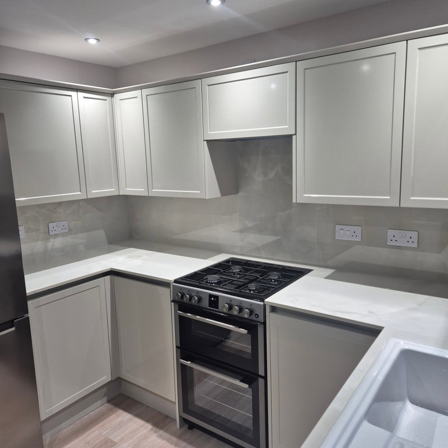 White and grey Shaker-style fitted kitchen installed by Paul Lynam in Peasedown St John