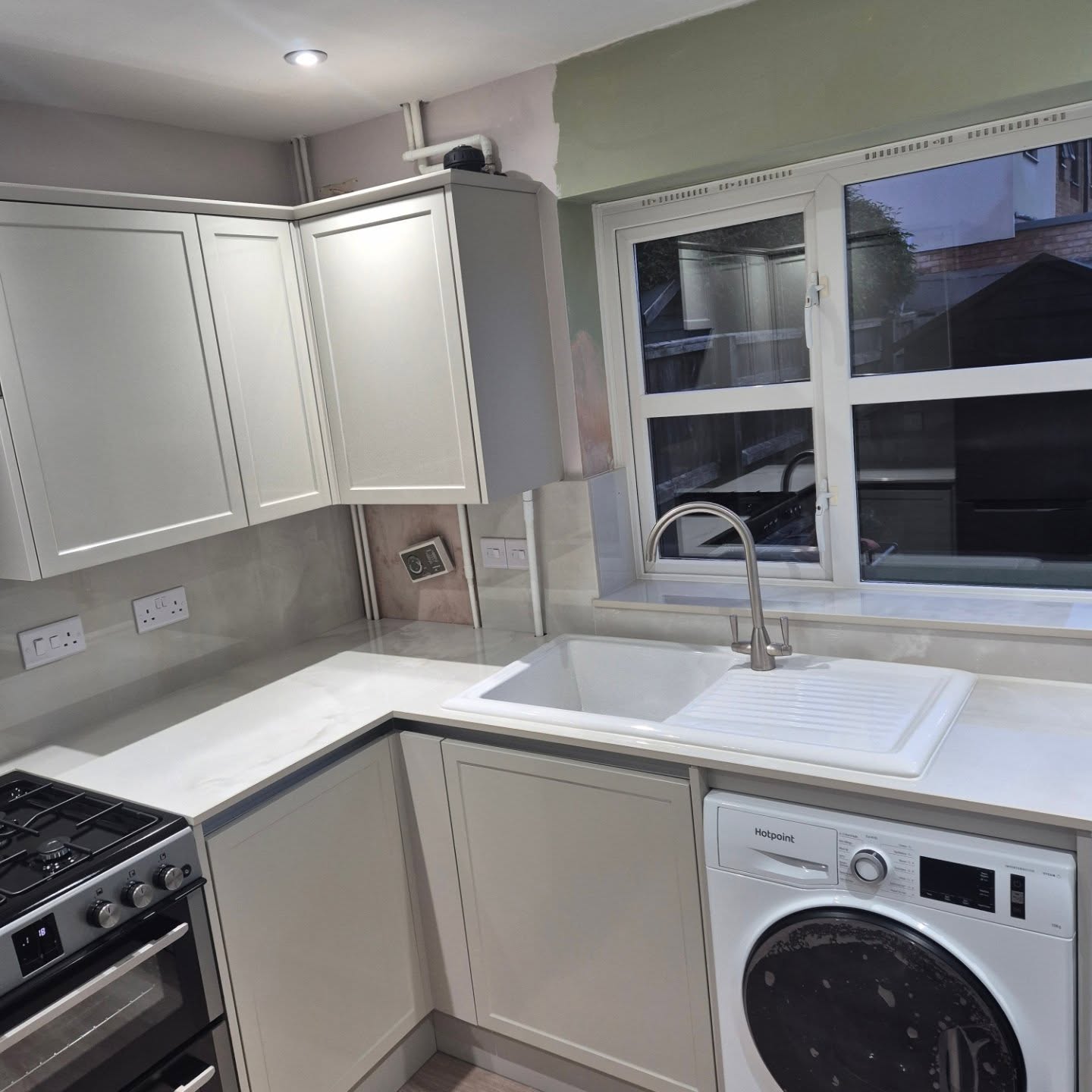 White and grey Shaker-style fitted kitchen installed by Paul Lynam in Peasedown St John